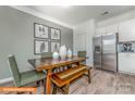 Bright dining area with wood table, bench, and green chairs at 1205 Red River Dr, Salisbury, NC 28144
