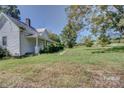 White farmhouse with wrap around porch and large yard at 1813 Saint Marks Church Rd, Crouse, NC 28033