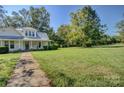 White farmhouse with wrap around porch and large yard at 1813 Saint Marks Church Rd, Crouse, NC 28033