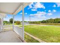 Covered porch overlooking a grassy yard and road at 215 Bethesda Rd, Statesville, NC 28677