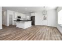 Modern kitchen with white cabinets, stainless steel appliances, and an island with granite countertops at 1977 Ripplerock Rd, Fort Mill, SC 29715