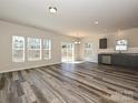 Open living room with grey flooring and access to backyard at 508 Kingsway Cir, Charlotte, NC 28214