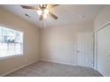 Bedroom with ceiling fan, window, and neutral walls at 102 S Little Texas Rd, Kannapolis, NC 28083