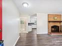 Living room with fireplace, kitchen view, and gray vinyl flooring at 111 Bobby Lee Ln # 18, Mooresville, NC 28115