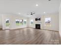 Spacious living room featuring hardwood floors, fireplace, and large windows at 1005 Piper Meadows Dr # 1, Waxhaw, NC 28173