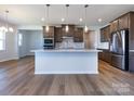 Modern kitchen with island, hardwood floors and stainless steel appliances at 113 Ryan Ln, Mooresville, NC 28115