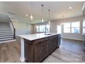 Modern kitchen with island, hardwood floors and stainless steel appliances at 113 Ryan Ln, Mooresville, NC 28115
