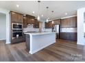Modern kitchen with island, hardwood floors and stainless steel appliances at 113 Ryan Ln, Mooresville, NC 28115