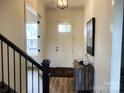Bright entryway with stylish console table and view to staircase at 139 Dabbling Duck Cir, Mooresville, NC 28117