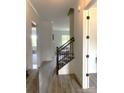 Modern stairwell with dark wood railing and light flooring at 139 Dabbling Duck Cir, Mooresville, NC 28117