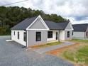 New home showcasing gray and white siding, a dark roof, and a landscaped yard at 9605 Hwy 52 N None # 4, Wadesboro, NC 28170