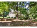 Two-story house with wrap-around porch, nestled among lush trees at 205 Vauxhall Dr, Shelby, NC 28150