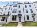 White three-story townhome with gray doors at 626 District Ct # 10, Fort Mill, SC 29708