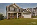 Two story home with green siding and white garage door at 108 Megby Trl, Statesville, NC 28677