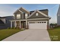 Two story home with green siding and white garage door at 108 Megby Trl, Statesville, NC 28677
