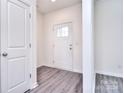 Bright foyer with white walls, gray floors, and interior door at 108 Megby Trl, Statesville, NC 28677