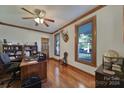 Home office features built-in shelves, hardwood floors, and large windows at 1976 Big Sky Dr, Chester, SC 29706