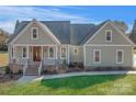 Craftsman style home with light green siding, double front doors, and brick accents at 113 Spring Forest Dr, Shelby, NC 28152