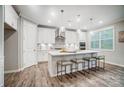 Bright kitchen featuring a large island with seating and stainless steel appliances at 9839 Quercus Ln, Huntersville, NC 28078