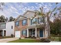 Two-story brick home with front porch and landscaped yard at 6822 Broad Valley Ct, Charlotte, NC 28216