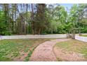 Fenced backyard with a brick path leading to gate at 15016 Rocky River Rd, Davidson, NC 28036