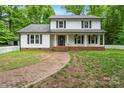 Two-story home with a brick walkway and charming porch at 15016 Rocky River Rd, Davidson, NC 28036