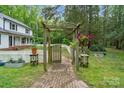 Brick pathway leads to a wooden arbor and fenced backyard at 15016 Rocky River Rd, Davidson, NC 28036
