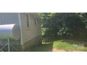 Side view of house showing grey siding and large tree at 335 Rosenwald School St, Catawba, NC 28609