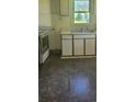 Older kitchen with double sink and white cabinets at 335 Rosenwald School St, Catawba, NC 28609