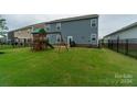 Spacious backyard featuring a playset and fenced area at 424 Wharton St, Monroe, NC 28110