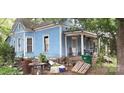 Side view of blue Victorian home needing some repairs at 118 Summit Ave, Albemarle, NC 28001
