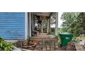 Small front porch with wooden floor and railing, needs some repairs at 118 Summit Ave, Albemarle, NC 28001