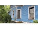 Blue house exterior with several windows, showing signs of age and needs some repairs at 118 Summit Ave, Albemarle, NC 28001