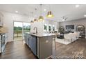 Open kitchen layout with island, stainless steel appliances, and living room view at 903 Woodington Ln # 78, Charlotte, NC 28214