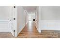 Bright hallway with hardwood floors and white wainscoting at 2003 Cedar Falls Dr # 69, Waxhaw, NC 28173