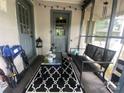 Screened porch with seating and rug at 6401 N Matson St, Kershaw, SC 29067