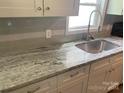 Kitchen boasts granite countertops and modern white cabinets at 7067 Citation St, York, SC 29745