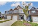 Three-story townhouses available in new community. Features gray siding and stone accents at 6280 Culbert St # 190, Harrisburg, NC 28075