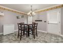 Kitchen dining area with table and four chairs at 1820 Oakdale Green Dr, Charlotte, NC 28216