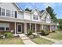 Brick townhouses with updated landscaping and inviting front porches at 12914 Mosby Ln, Charlotte, NC 28273