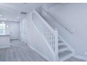 White staircase with simple, clean railing in a light-toned hallway at 12914 Mosby Ln, Charlotte, NC 28273