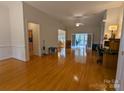 Spacious living room with hardwood floors, fireplace and sunroom access at 5916 Meadowmere Dr, Monroe, NC 28110