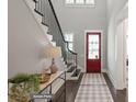 Bright entryway with hardwood floors, red door and staircase at 3314 Lakeside Dr, Charlotte, NC 28270