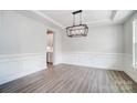 Spacious dining room featuring hardwood floors and a modern chandelier at 2016 Cedar Falls Dr # 7, Waxhaw, NC 28173