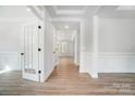 Bright hallway with hardwood floors and French doors leading to other rooms at 2016 Cedar Falls Dr # 7, Waxhaw, NC 28173