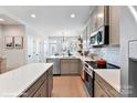 Modern kitchen with gray cabinets and white backsplash at 512 Lockwood Creek Dr # 29, Charlotte, NC 28208