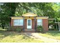 Brick home with covered porch and mature trees at 14903 Beatties Ford Rd, Huntersville, NC 28078