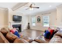 Bright living room with hardwood floors, fireplace, and two leather sofas at 4198 Pickering Dr, Hickory, NC 28602