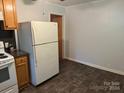 Galley kitchen with wood cabinets and tiled floor at 415 Eastover Ave, Norwood, NC 28128