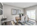 Bright dining area with a wooden table and access to a patio at 1979 Tupelo Grove Ln, Gastonia, NC 28054